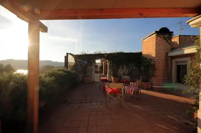 a patio with tables and chairs on a house at Beautiful Loft in Ponte Milvio with terrace in Rome