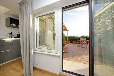 a kitchen with a sliding glass door leading to a patio at Beautiful Loft in Ponte Milvio with terrace in Rome