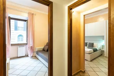 a room with a bedroom with a bed and a mirror at Trastevere Home by Rental in Rome in Rome