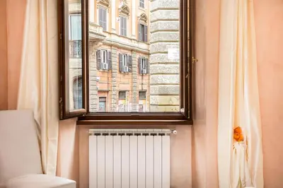 a window in a bathroom with a radiator and a building at Trastevere Home by Rental in Rome in Rome