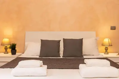 a bedroom with a bed with two pillows at Trastevere Home by Rental in Rome in Rome