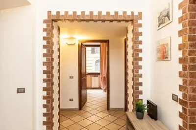 a hallway with a brick wall and a doorway at Trastevere Home by Rental in Rome in Rome