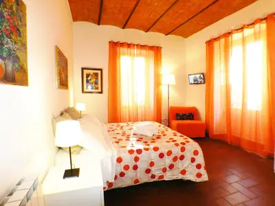 a bedroom with a bed with a polka dot blanket at The Artist House in Rome