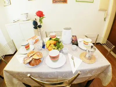 a table with plates of food and fruit on it at The Artist House in Rome