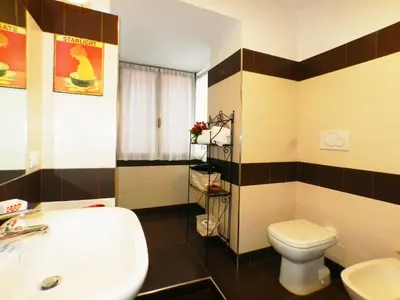 a bathroom with a white sink and a toilet at The Artist House in Rome