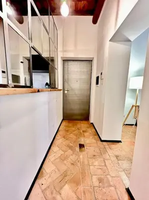 a room with a hallway with a door and a tile floor at Appartamento nel cuore di Roma in Rome