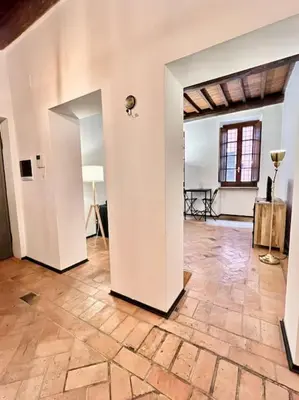 an empty room with white walls and a wooden floor at Appartamento nel cuore di Roma in Rome