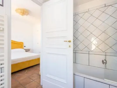 a white bathroom with a bed and a shower at Panoramic Terrace Trastevere in Rome
