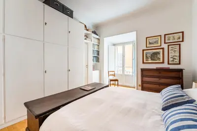 a bedroom with a large bed and a desk at Maison Regola, Styilish Apt in Campo De Fiori in Rome