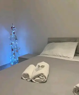a bed with a towel on it with a christmas tree at Bignami street in Rome