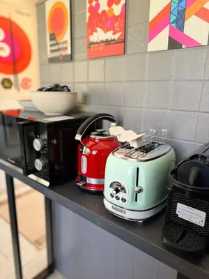 a counter with two toasters sitting on a shelf at Otranto 36 in Rome