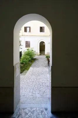 an archway leading into a building with a stone walkway at Otranto 36 in Rome