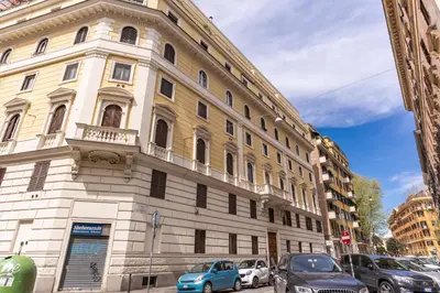 a large building with cars parked in front of it at Otranto 36 in Rome