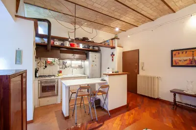 a kitchen with a table and chairs in a room at Il giardino di Bobo in Rome