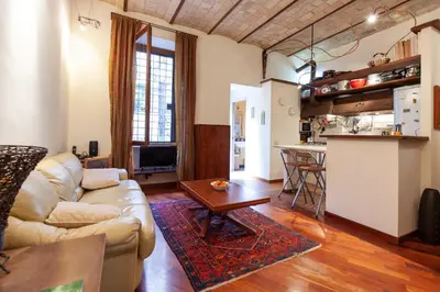 a living room with a couch and a table at Il giardino di Bobo in Rome