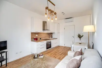 a living room with a couch and a kitchen at Naos Suite close Popolo Square in Rome