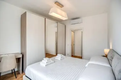 a bedroom with two beds and a desk and a chair at Naos Suite close Popolo Square in Rome