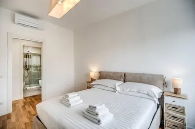 a bedroom with a white bed with towels on it at Naos Suite close Popolo Square in Rome
