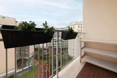 a balcony with two potted plants on the ledge at GuestHost - Sunny Apartment Piramide in Rome