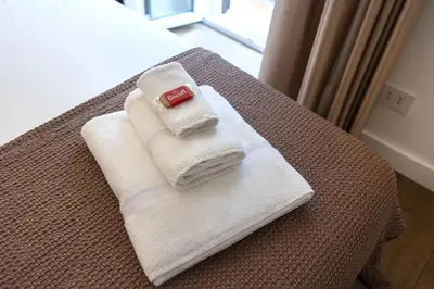 a pile of towels sitting on top of a bed at Barcaccia Exclusive apartment in Rome