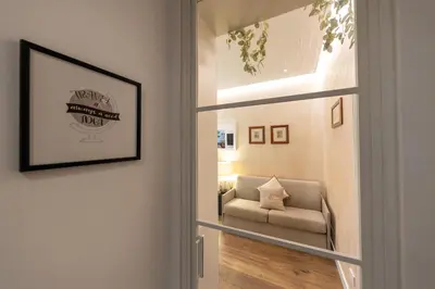 a door leading into a living room with a couch at Barcaccia Exclusive apartment in Rome