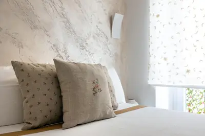 a bedroom with a bed with two pillows and a window at Barcaccia Exclusive apartment in Rome