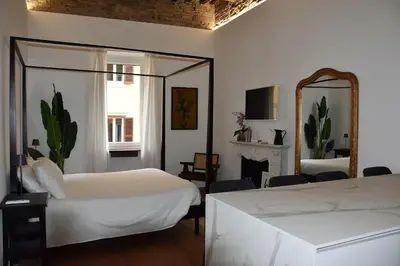 a bedroom with two beds and a mirror and a fireplace at Fontana Luxury Home in Rome
