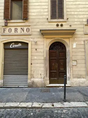 a building with two garage doors on a street at Fontana Luxury Home in Rome