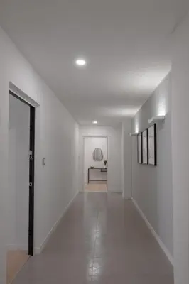 an empty hallway with white walls and a door at Noah Charme in Rome