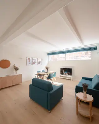 a living room with two blue couches and a table at Noah Charme in Rome