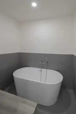 a white bath tub sitting in a bathroom at Matilda Charme in Rome