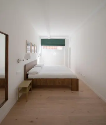 a white bedroom with a bed and a window at Matilda Charme in Rome