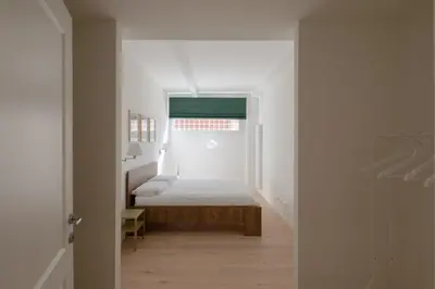 a bedroom with a bed in a white room at Matilda Charme in Rome