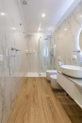 a bathroom with two sinks and a shower at Elegantia Luxury Rooms in Rome