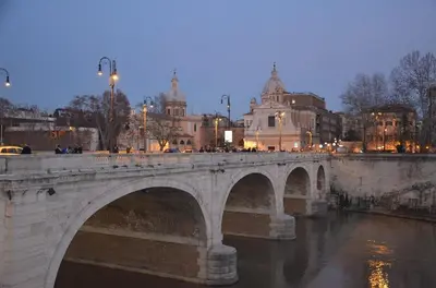 a bridge over a river in a city at Elegantia Luxury Rooms in Rome