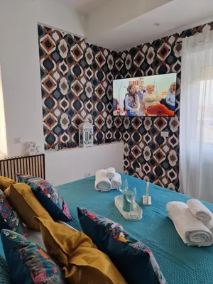 a table with a blue table cloth and pillows at Home K&Y Elite Pineta in Rome