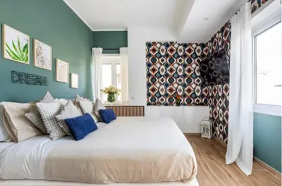a bedroom with a large white bed with blue walls at Home K&Y Elite Pineta in Rome