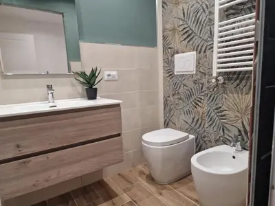 a bathroom with a sink and a toilet and a mirror at Home K&Y Elite Pineta in Rome