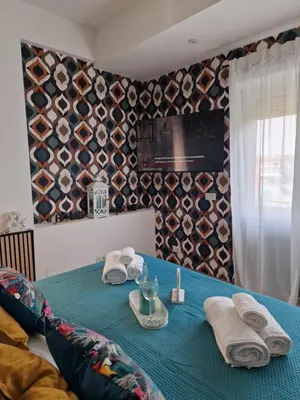 a blue table with towels and napkins on it at Home K&Y Elite Pineta in Rome