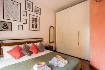 a bedroom with a bed with towels on it at Appartamento via di San Martino ai Monti in Rome