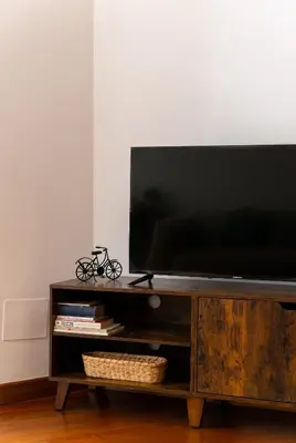 a flat screen tv sitting on top of a wooden entertainment center at Appartamento via di San Martino ai Monti in Rome