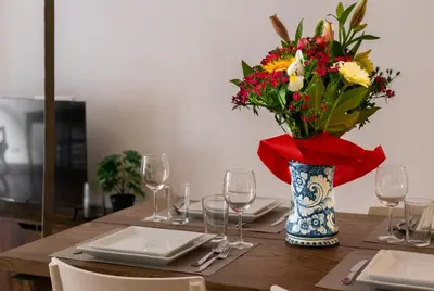 a table with a vase of flowers on top of it at Appartamento via di San Martino ai Monti in Rome