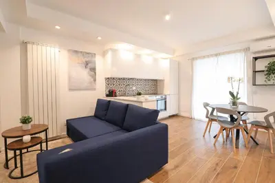 a living room with a blue couch and a table at Ziani 5 Rome Vatican Apartment in Rome