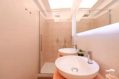 a bathroom with a sink and a shower at Ziani 5 Rome Vatican Apartment in Rome