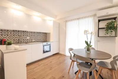 a kitchen and dining room with a table and chairs at Ziani 5 Rome Vatican Apartment in Rome