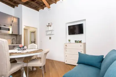 a kitchen and dining room with a table and chairs at Navona Atmosphere A few meters from Piazza Navona !! in Rome