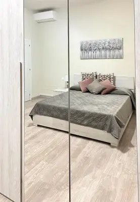 a bedroom with a bed with a glass wall at suite magenta in Rome