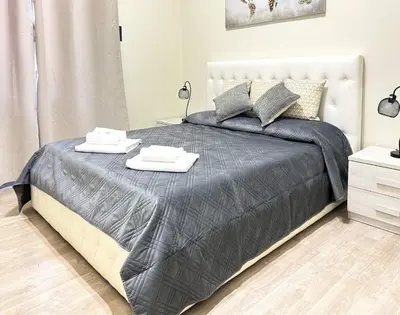 a bedroom with a bed with two towels on it at suite magenta in Rome