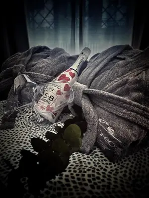 a bottle on a towel on a bed at IL NINFEO San Giovanni ROMA in Rome