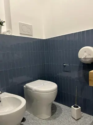a bathroom with a white toilet and a sink at IL NINFEO San Giovanni ROMA in Rome